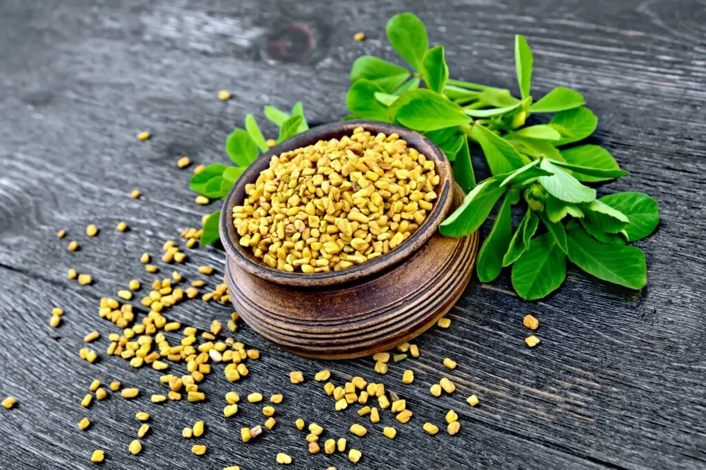 Fenugreek with leaf in bowl on board