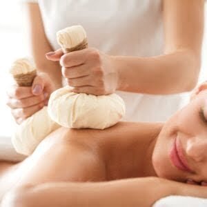Herbal massage. Masseur doing massage for deep relaxation