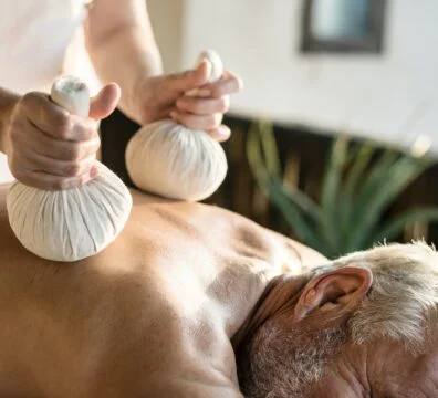 Massage therapist massaging at a spa