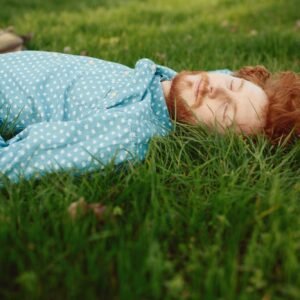 Portrait of a ginger man relaxing on the grass