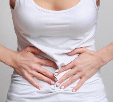 Woman with stomachache, having food poisoning, grey background