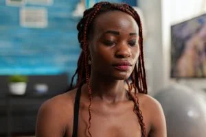 Black woman training body and mind meditating