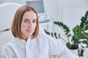 Elegant redheaded female resting in beauty clinic
